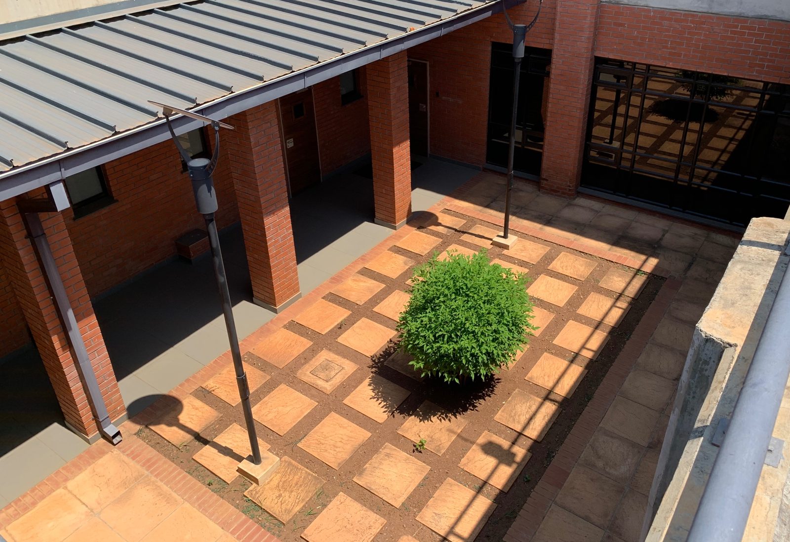 A paved courtyard brings light and air to the rooms around it