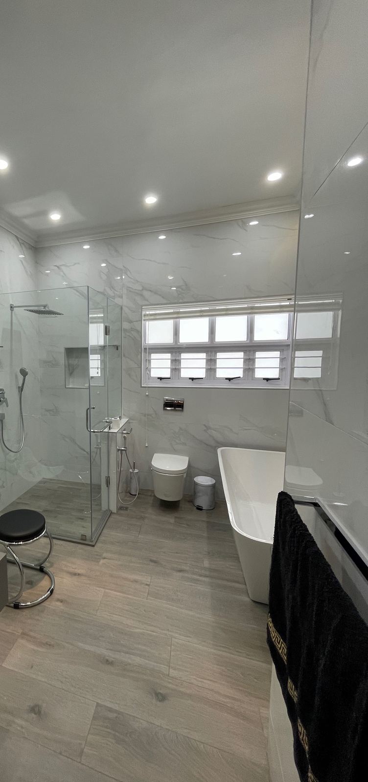 A re-planned bathroom with a freestanding bath and walk-in shower