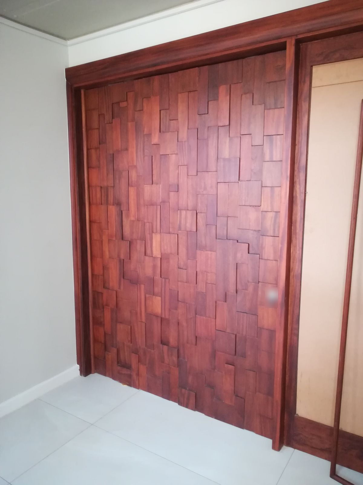 Sliding doors clad in a relief of solid timber blocks