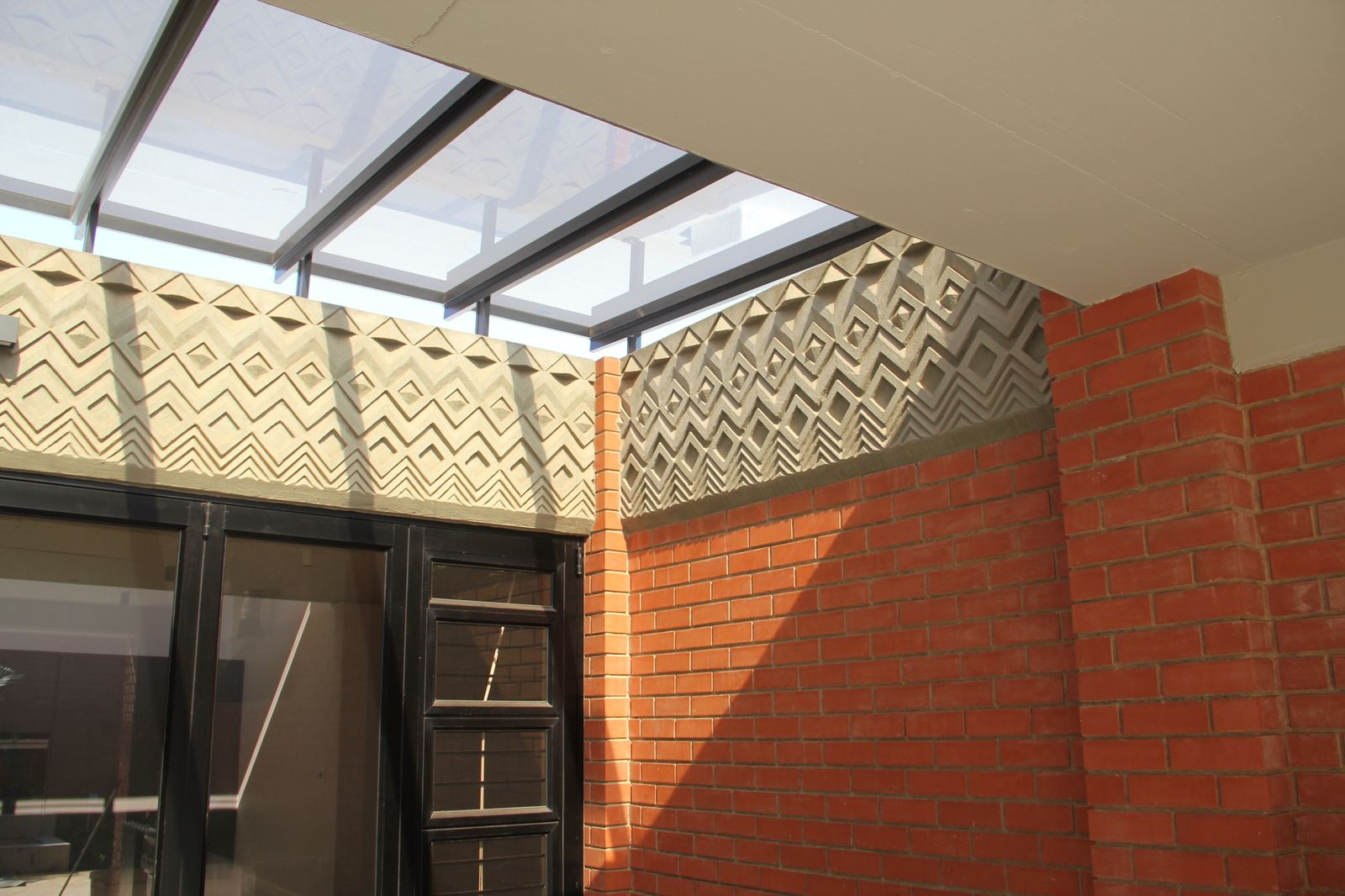 A skylit courtyard with a hand-made relief frieze