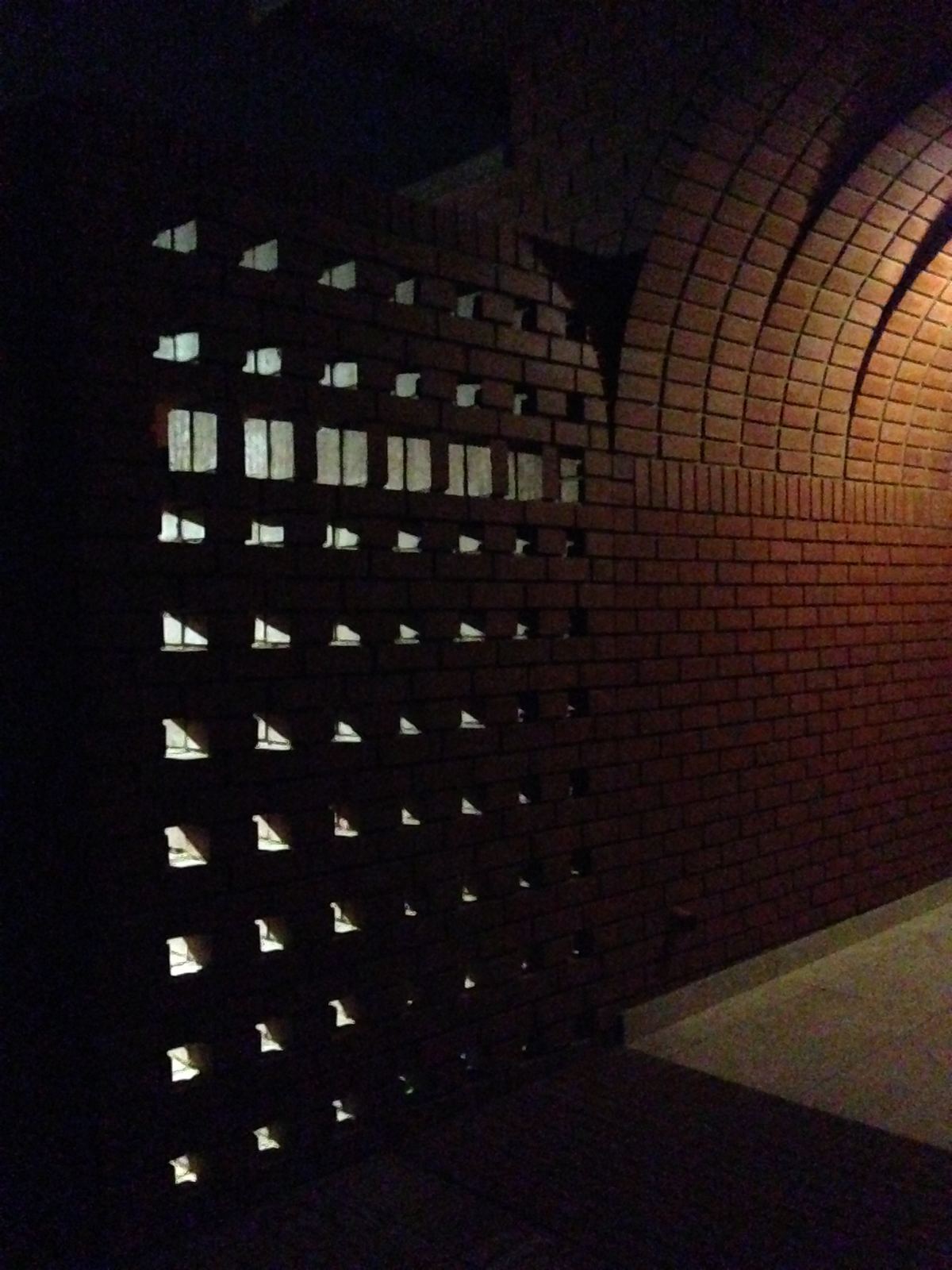 A brick grille glowing softly at night