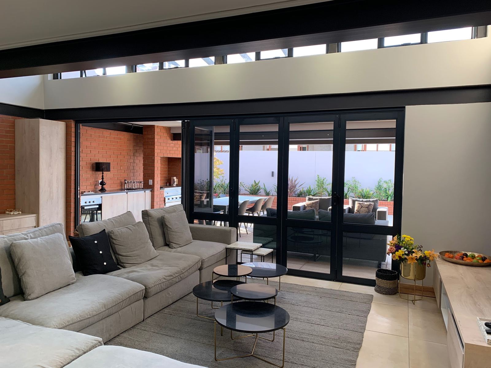 Clerestory windows above a living room that opens to the patio