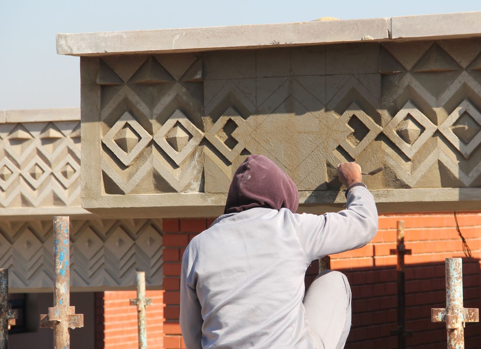 Traditional scratch-plaster relief, carved by hand on site